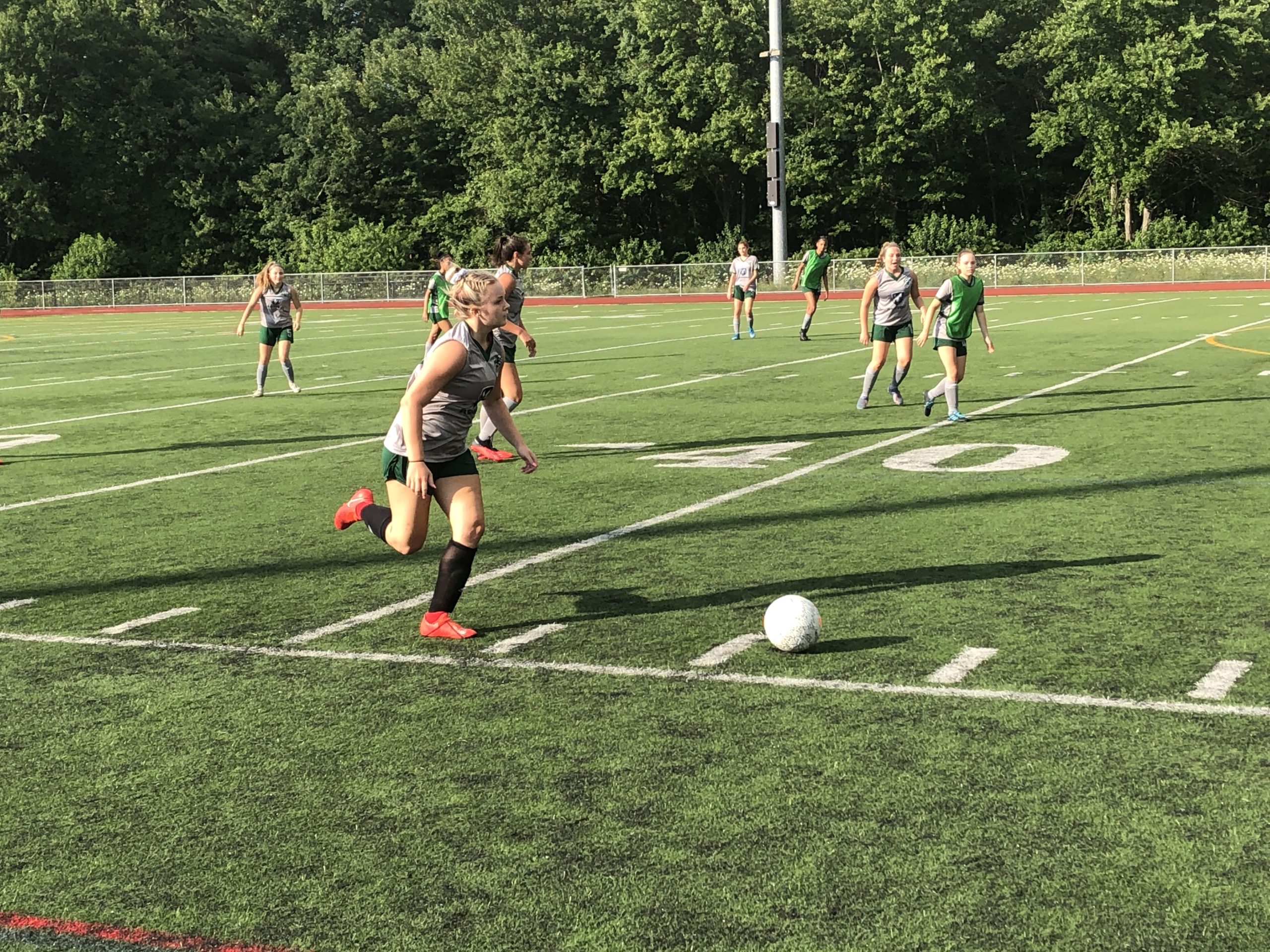 Girls dribbling down sideline Soccer